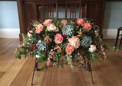 Elegant Floral Display. A stunning arrangement of peach and coral blooms with soft greenery, perfect for adding a romantic touch to any wedding venue