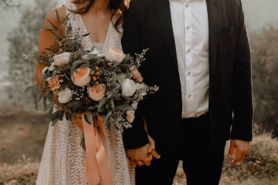 Bohemian Bridal Bouquet. A beautiful, loosely arranged bouquet of peach and ivory blooms with flowing foliage, perfect for a relaxed, romantic wedding
