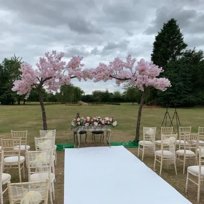 Pink Blossom Tree Arch – A beautiful display of soft pink blossom trees, creating a romantic setting for your wedding ceremony.